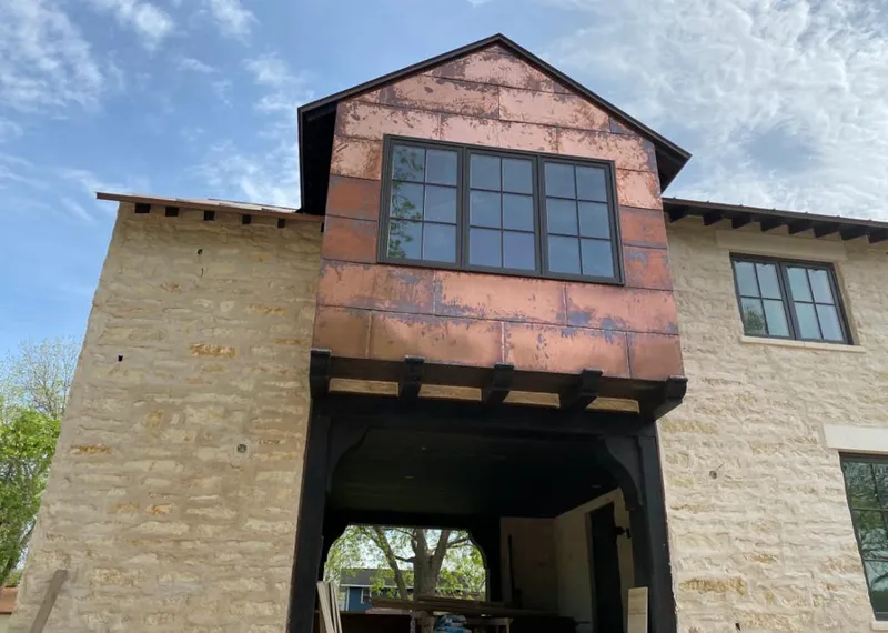 Copper metal panel facade on a stone building for Metal Roof Coating in Conroe