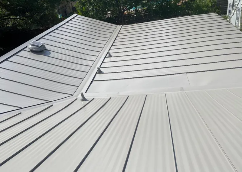 Solar attic fan installed on a metal roof for Roof Ventilation in Conroe